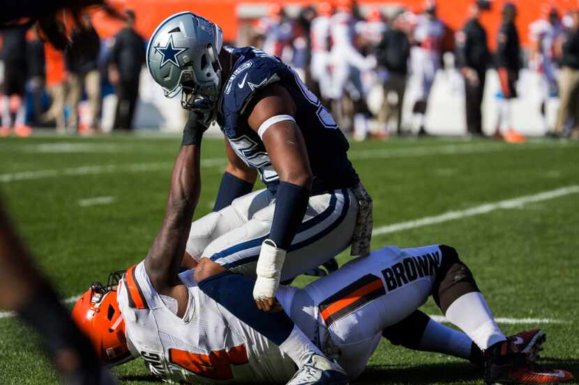 Dallas Cowboys defensive tackle David Irving (95) is punched by Cleveland Browns center...