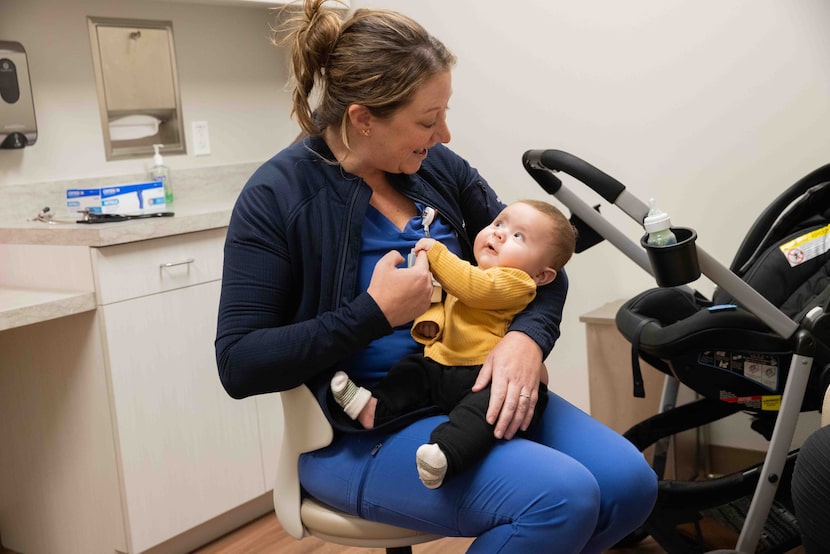 Nurse practitioner Casey Cox holds 4.5-month-old Atlas, who had open heart surgery in...