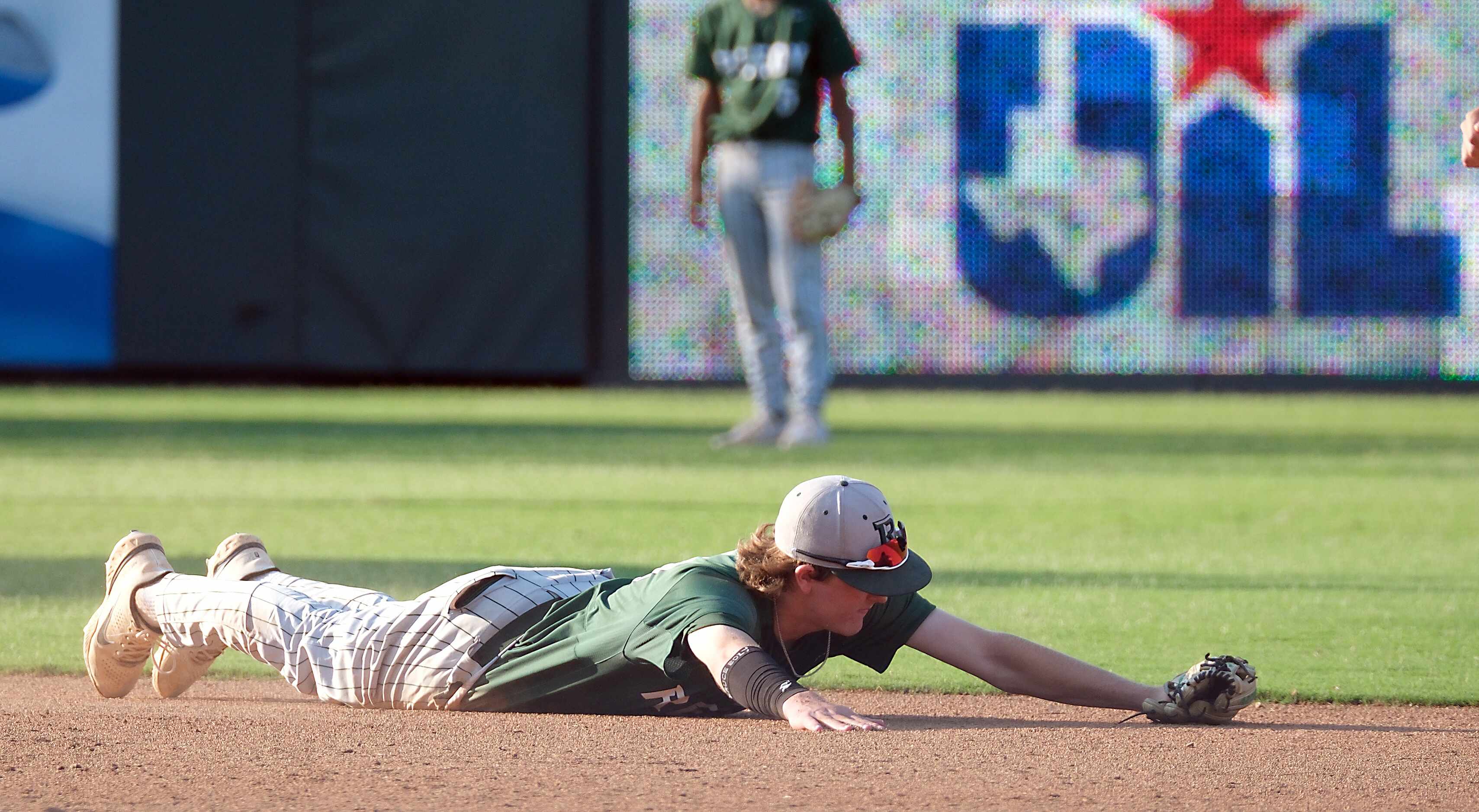 Frisco Reedy Brandon Huff, (11), lies flat on the ground after missing a single hit by ...