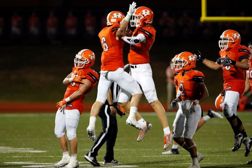Rockwall's Zach Henry (6) and Jacob Clark (12) celebrate with teammates at the end of their ...