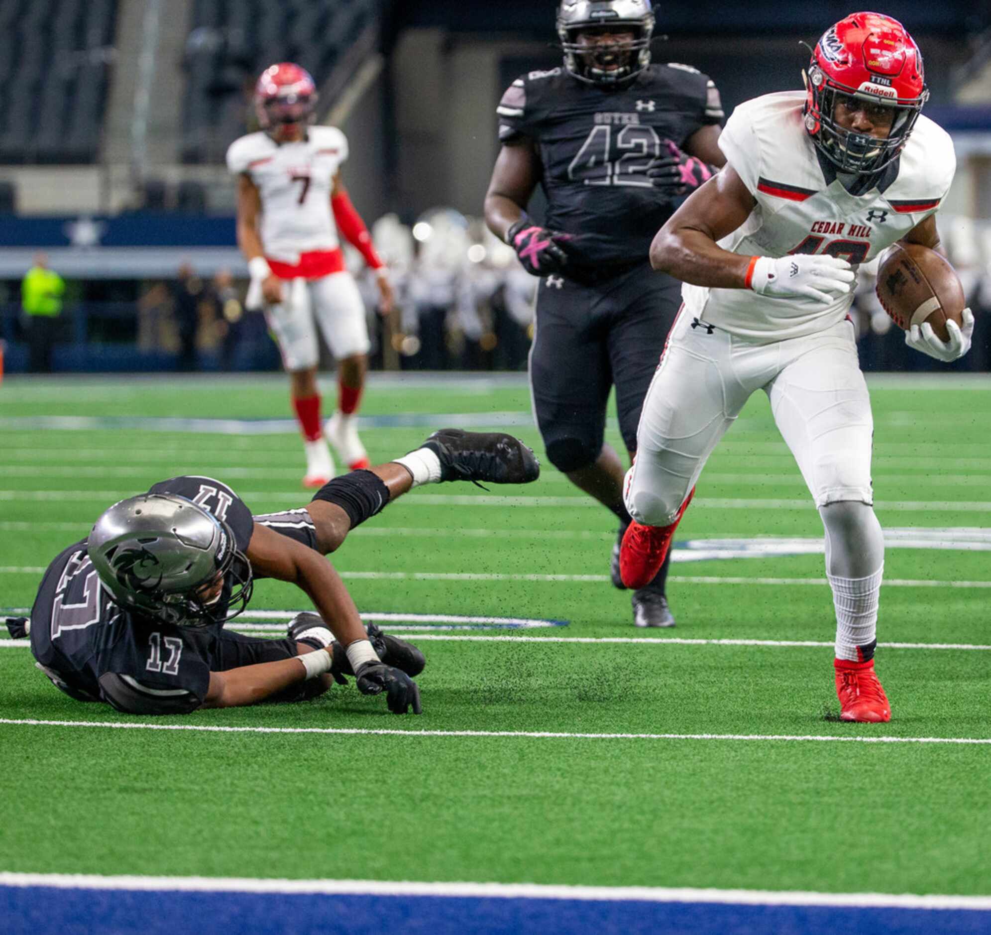 Cedar Hill wide receiver Brian Rainey (12) successfully pulls away from Denton Guyer...