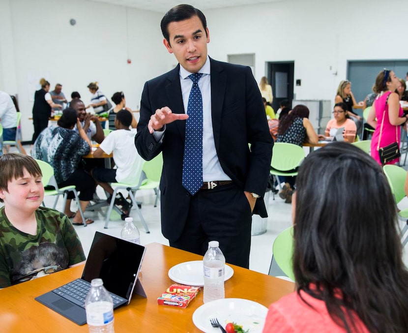 
DISD School Board President Miguel Solis chats with James (left) and Karen Slate.
