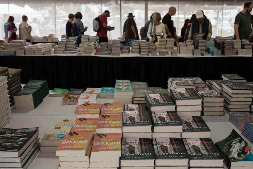 Festival goers look at books inside the Barnes and Noble tent during the Texas Book Festival...