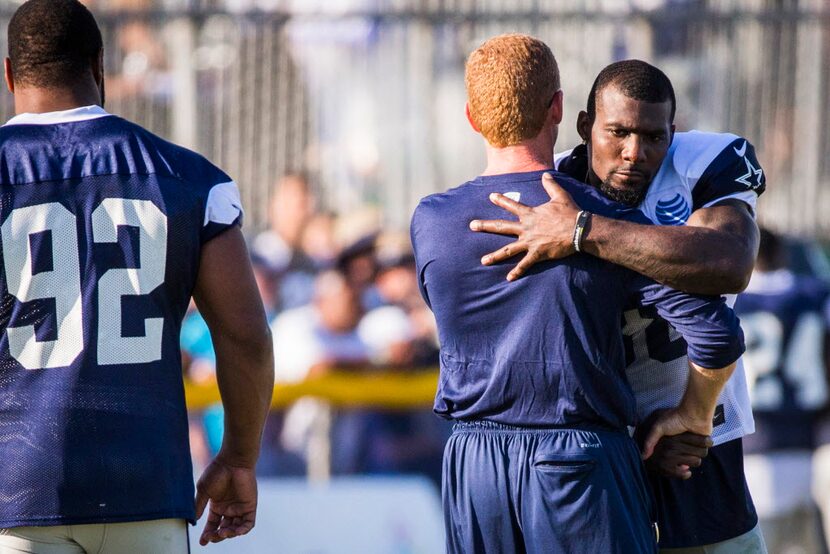 Dallas Cowboys head coach Jason Garrett hugs wide receiver Dez Bryant (88) after practice as...