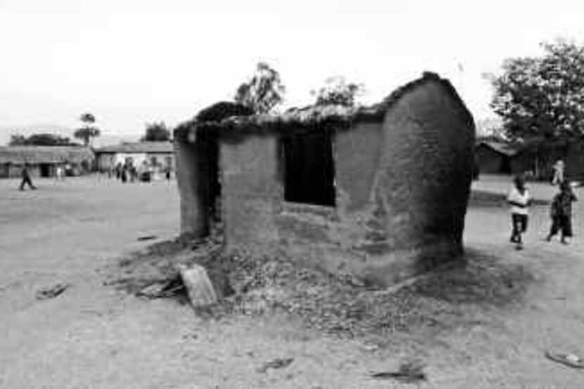 A burned-out hut remained in Sange, Congo, after a truck hauling fuel on a rural highway...