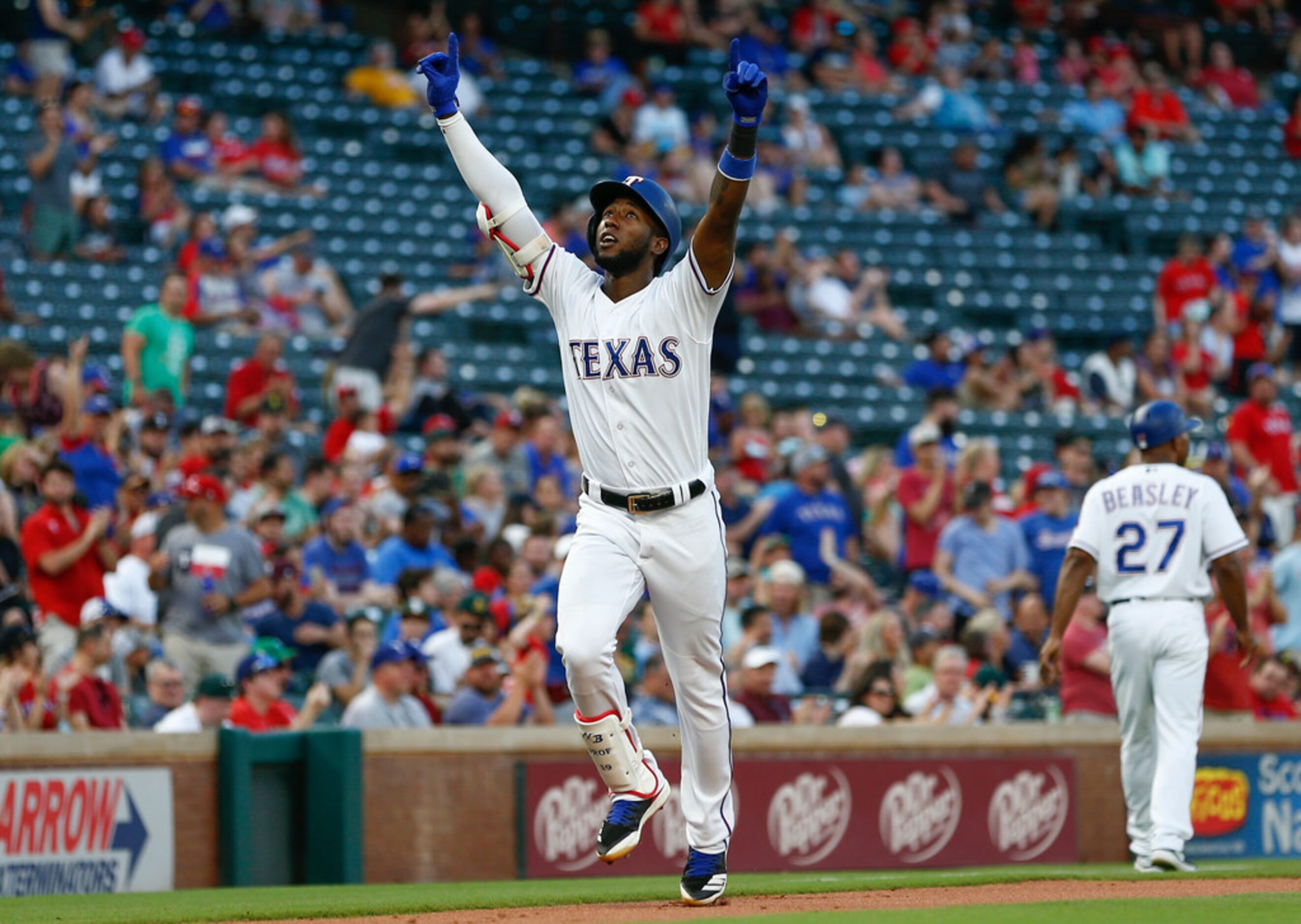 Texas Rangers' Jurickson Profar points to the sky as he arrives home following his solo home...