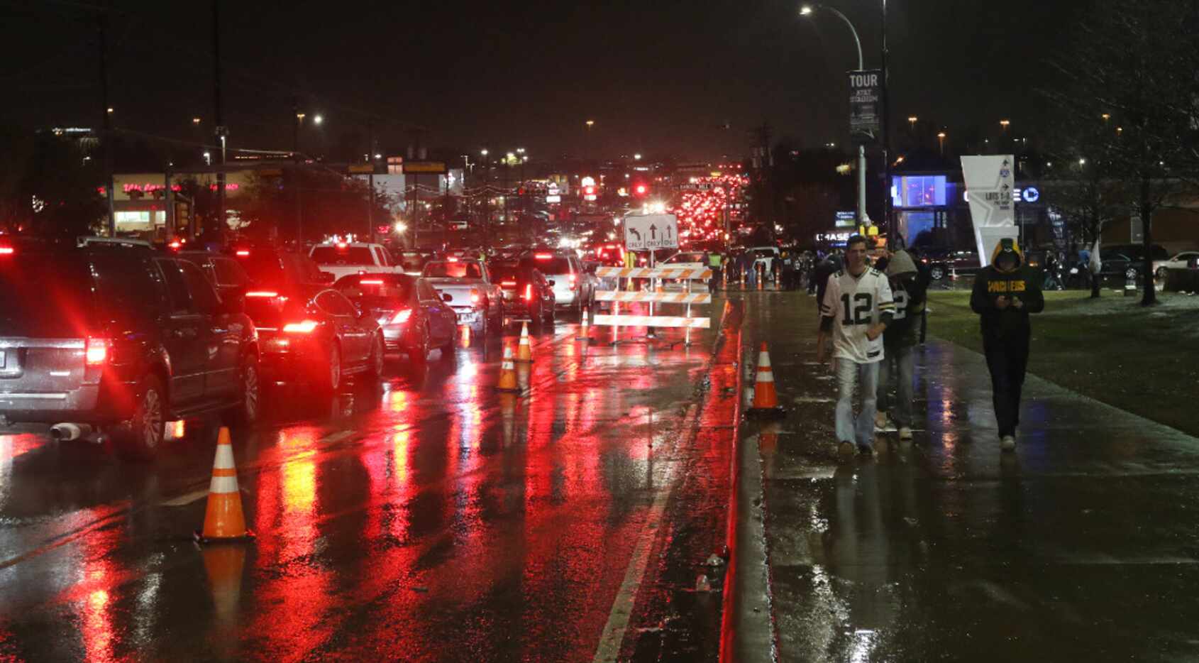 Traffic on Collins Street in front of AT&T Stadium as fans drive in the rain after the game.