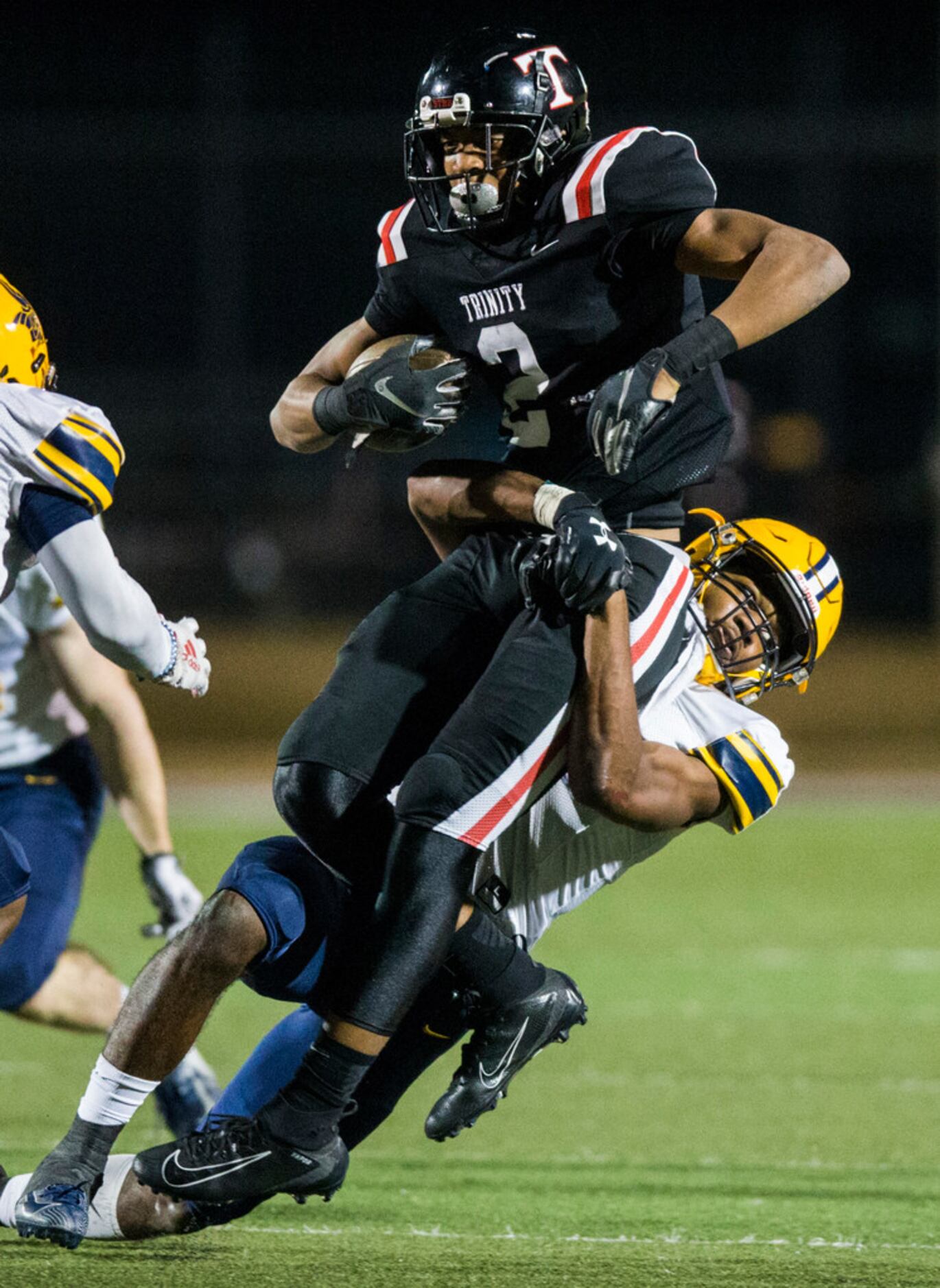 Euless Trinity running back Ollie Gordon (2) is tackled by Arlington Lamar defensive back...