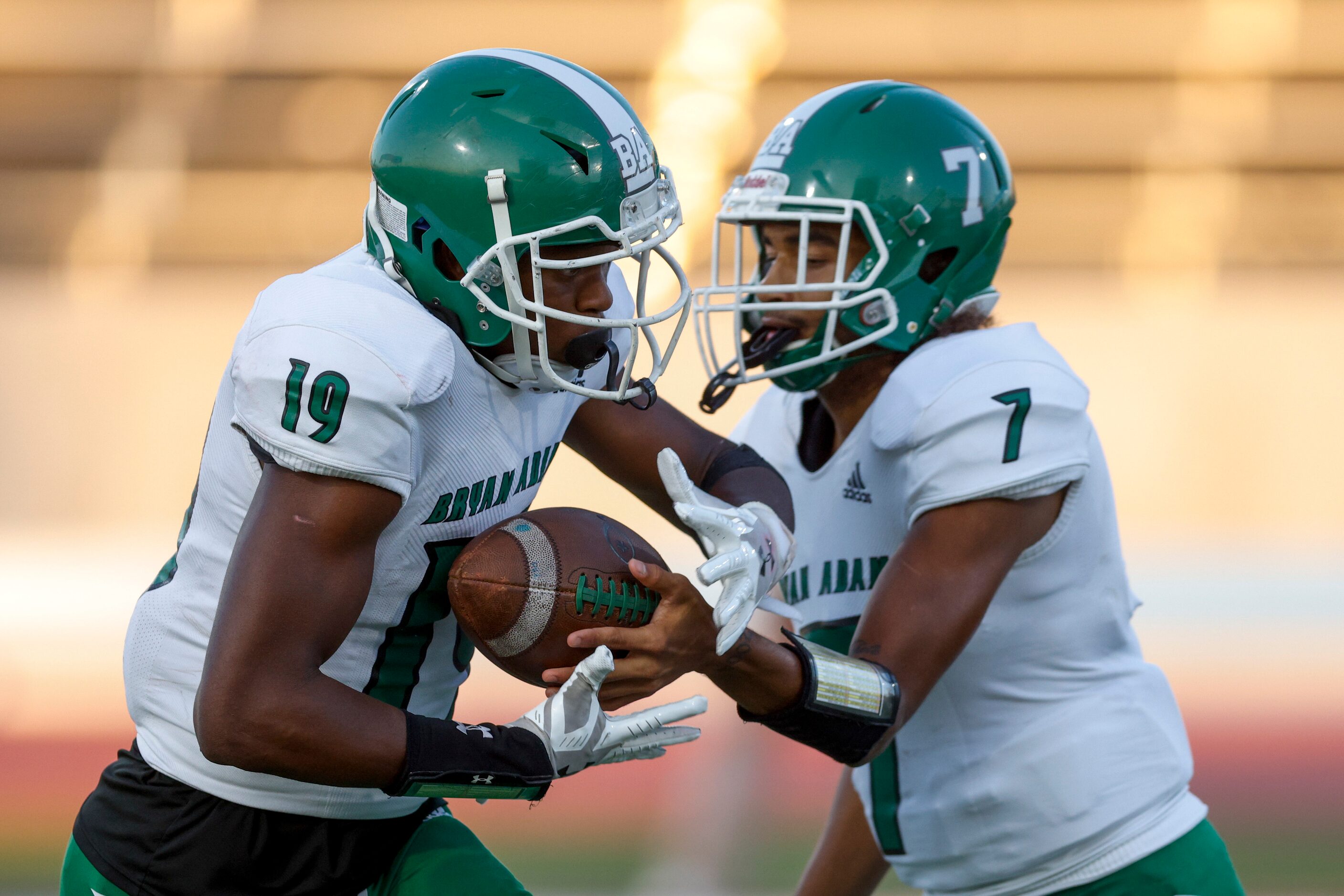 Bryan Adams quarterback Rayvon Jackson Jr. (7) hands the ball to running back Jon’Trevious...