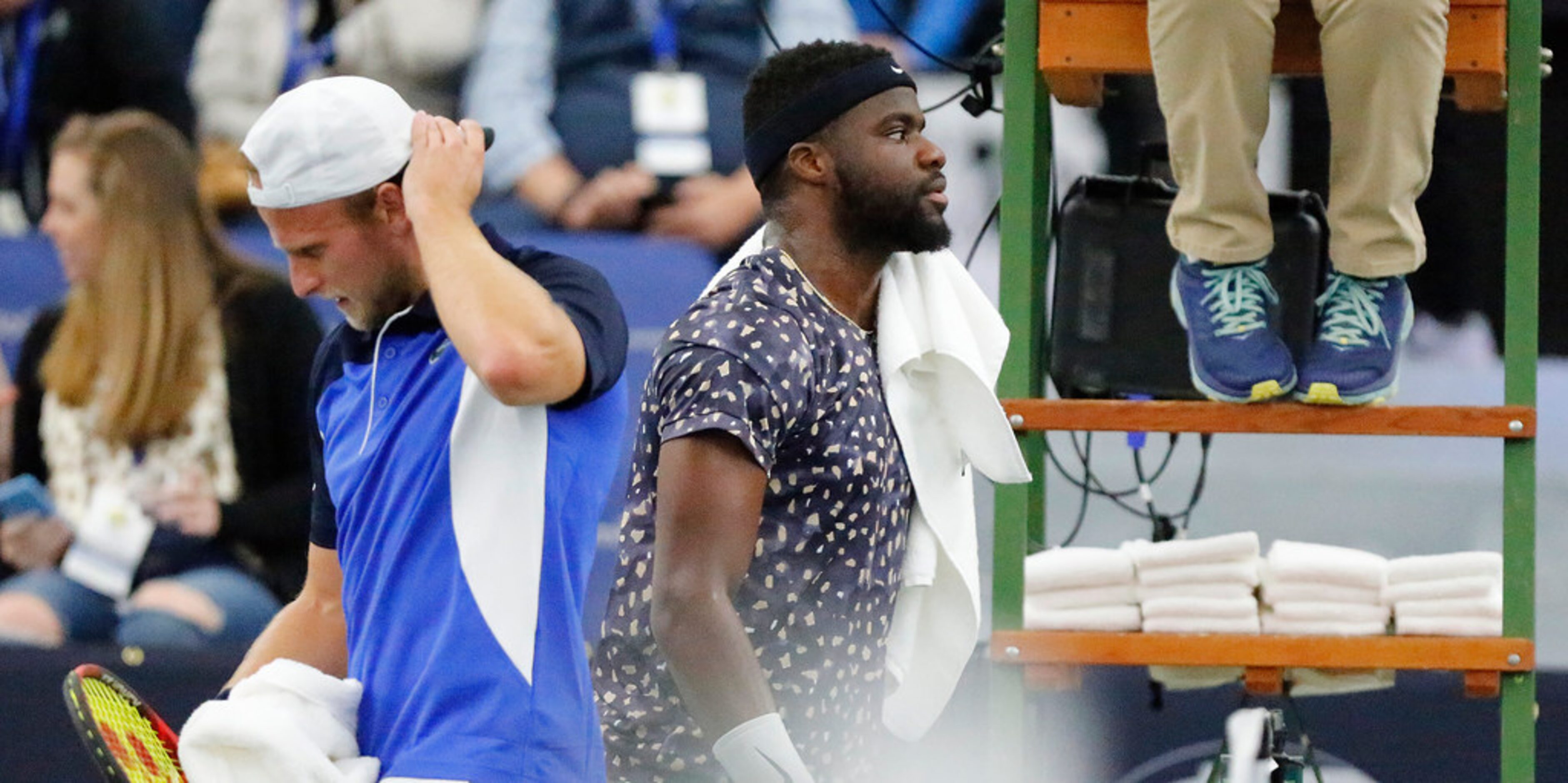 Frances Tiafoe (right), ranked number one in the tournament, passes Denis Kudlak (left),...