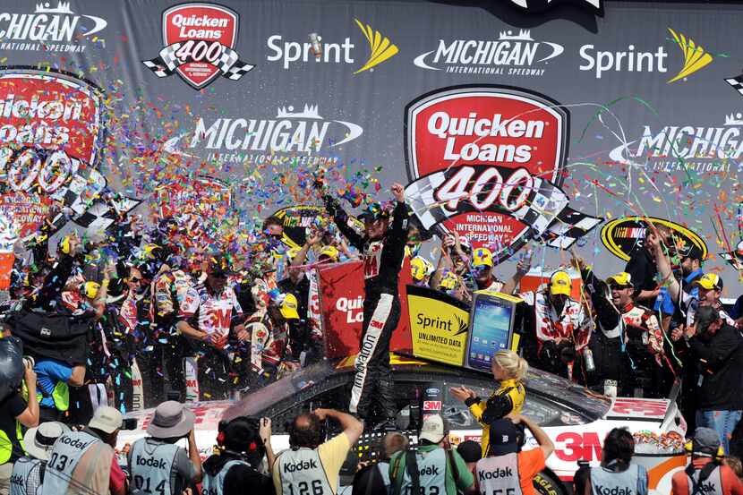 Sprint Cup Series driver Greg Biffle celebrates in the winner's circle after winning the...