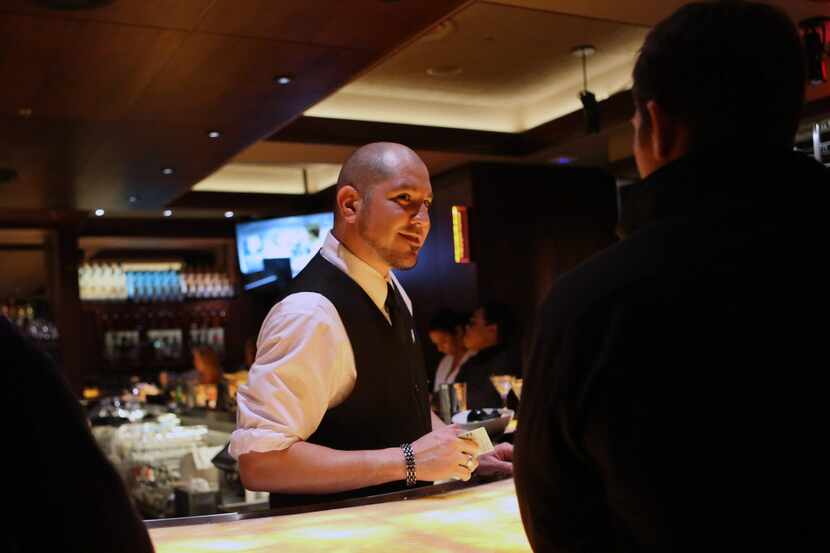Truluck's Uptown's bartender Ricardo Cantu speaks with a guest Thursday, March 5, 2015 in...