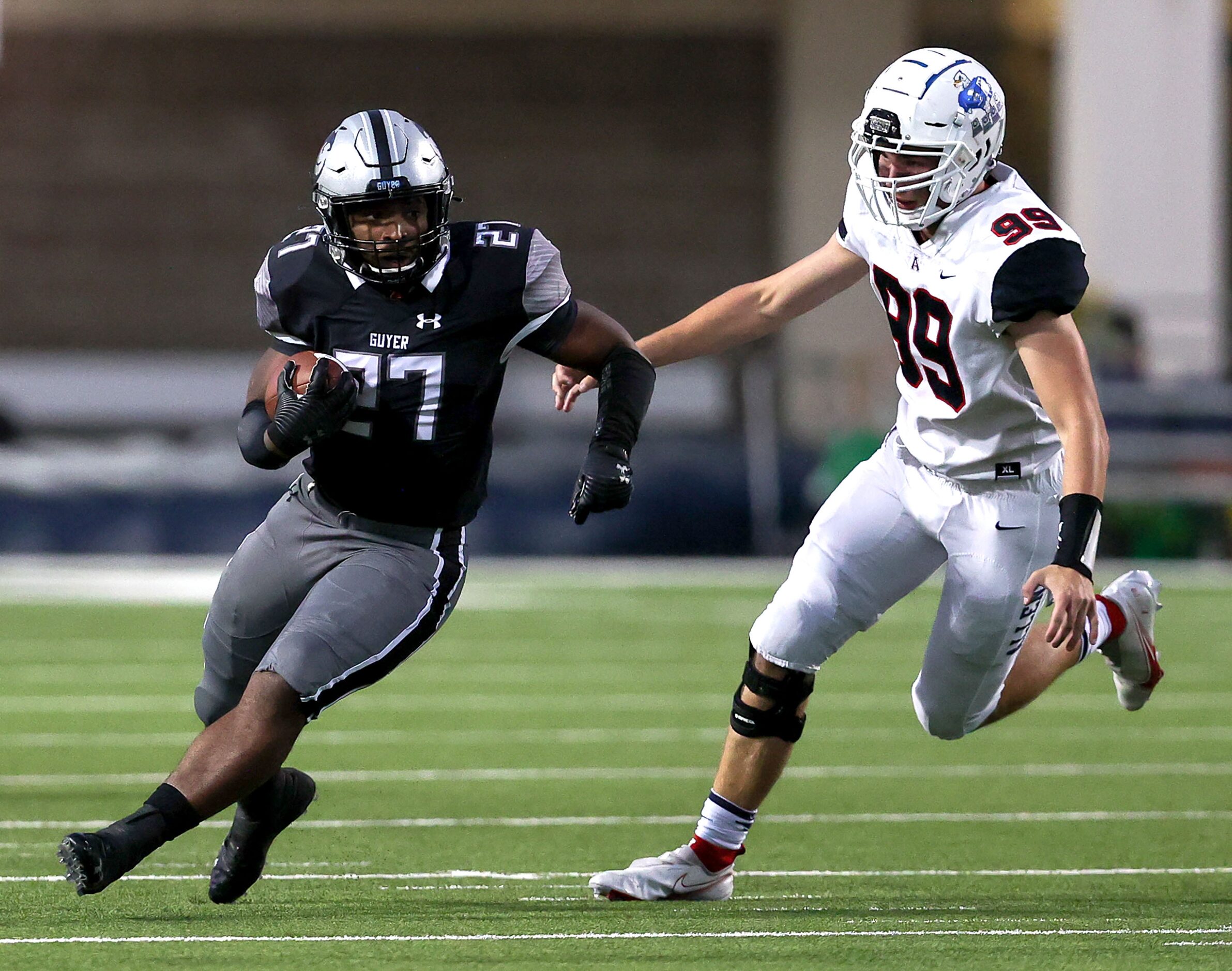 Denton Guyer running back Byron Phillips (27) tries to avoid Allen defensive lineman Blake...