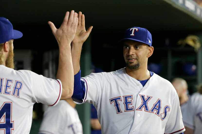 Texas Rangers' Andrew Cashner (54) congratulates Tyson Ross, right, on his quality outing...