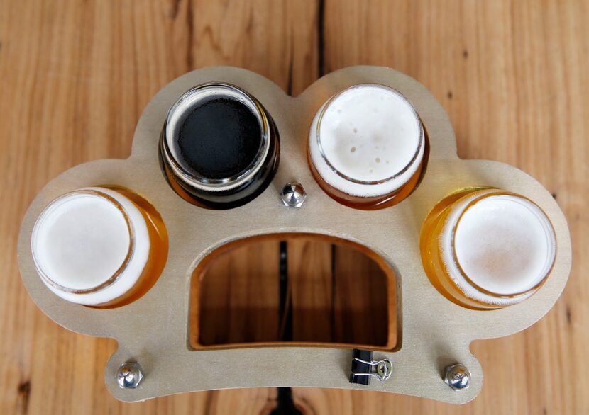 Flights of beer come served in a tray shaped like brass knuckles at Austin Beerworks. 