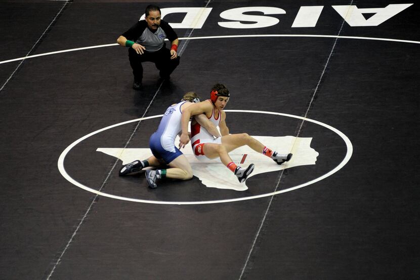 Katy's Christian Martinez and Flower Mounds' Dylan Akers battle for the 126-pound weight...
