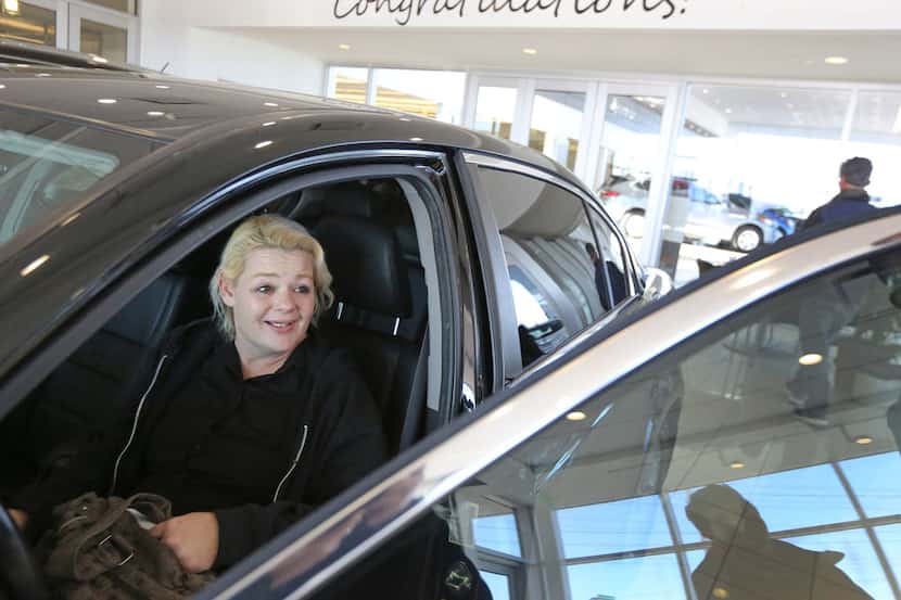 Christal Scott reacts to receiving a 2012 Honda Accord at Ewing Buick-GMC dealership in...