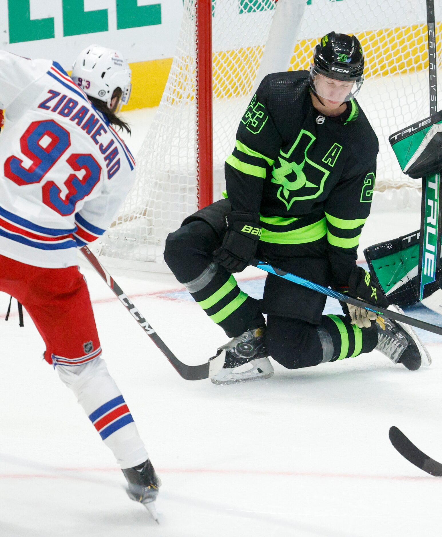 Dallas Stars defenseman Esa Lindell (23) blocks a shot from New York Rangers center Mika...