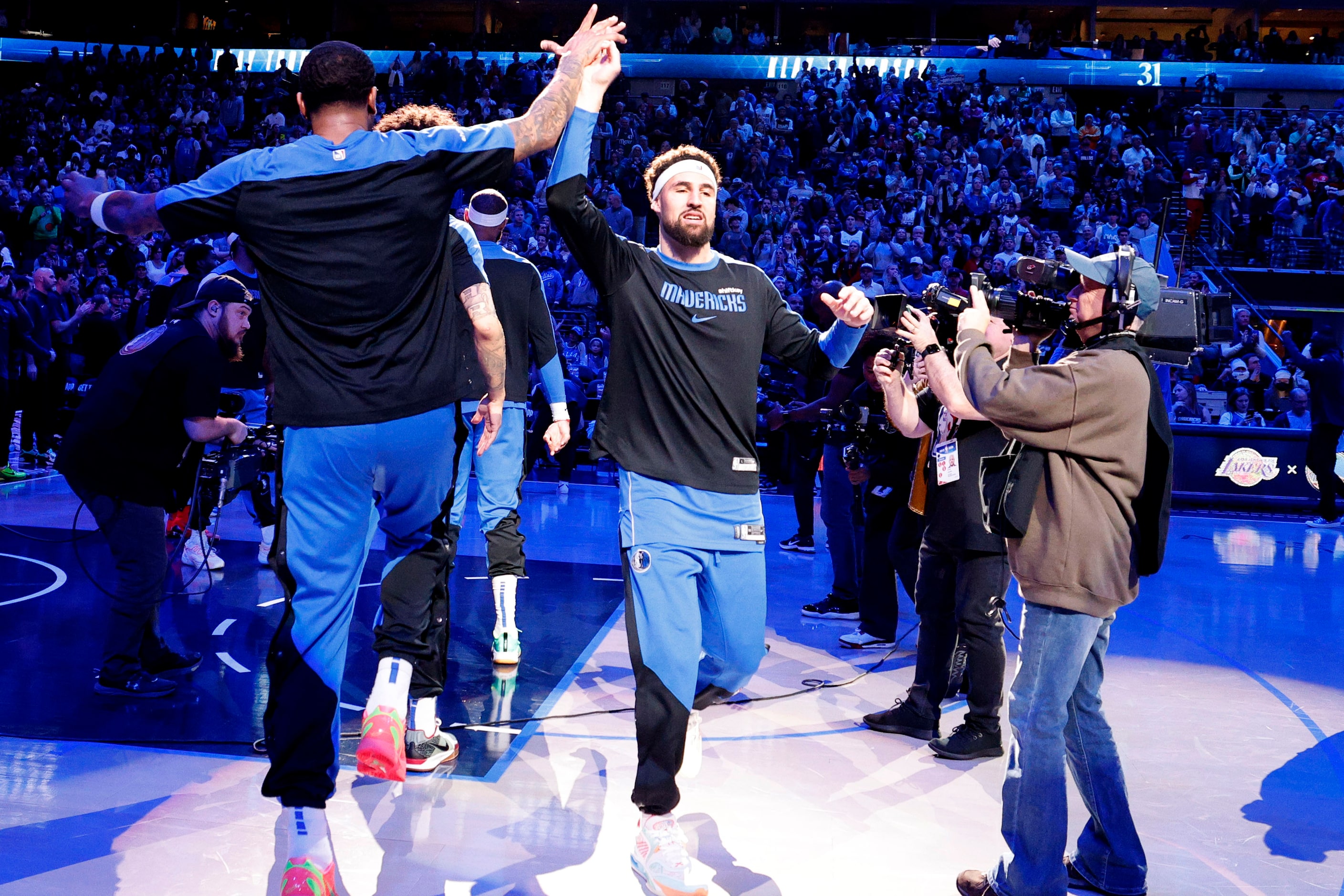 Dallas Mavericks guard Klay Thompson (31) gets a high-five from his teammate during the...