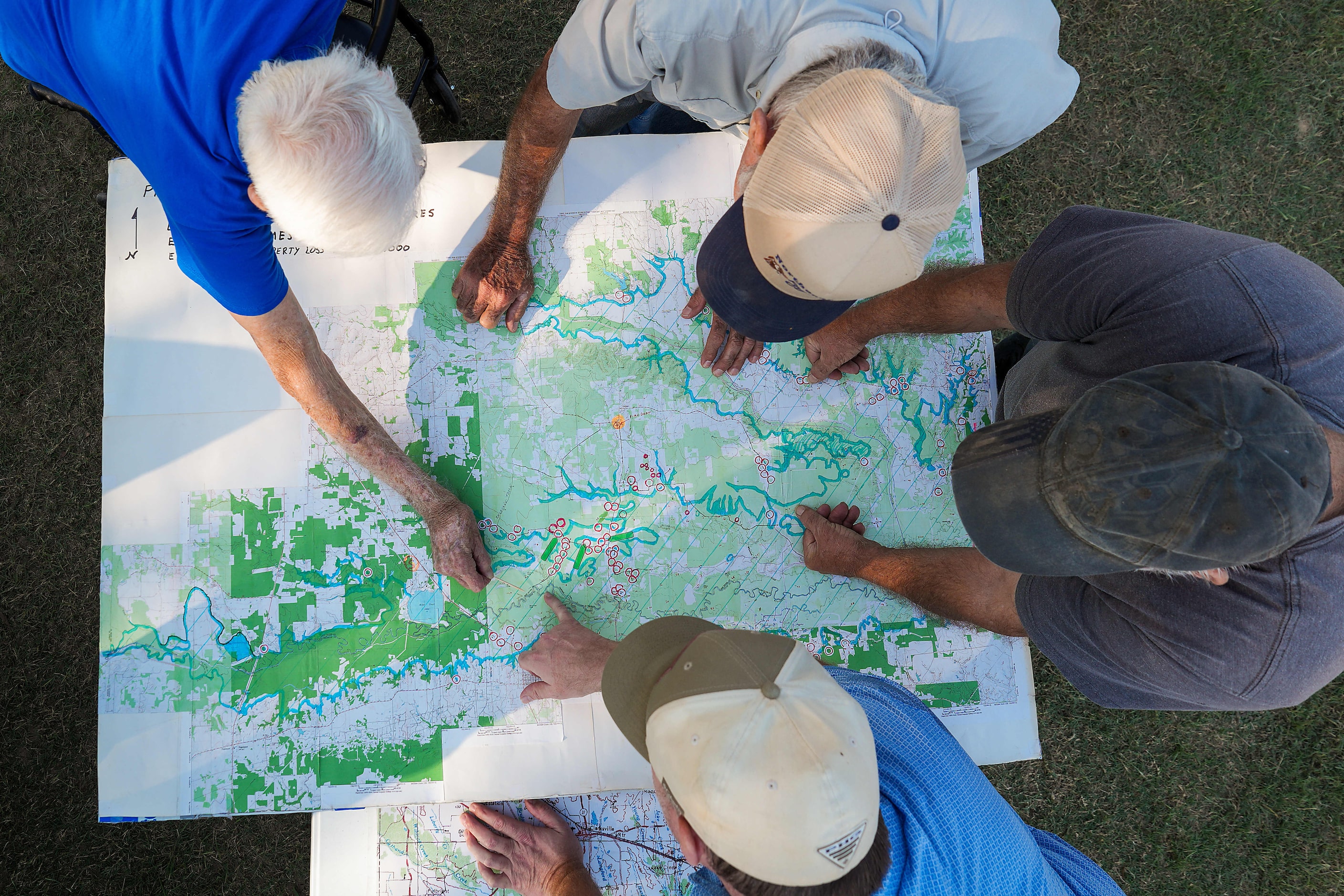 Gary Cheatwood, 85, (top left) and his son Gary Cheatwood Jr., 48, (bottom) go over a map...