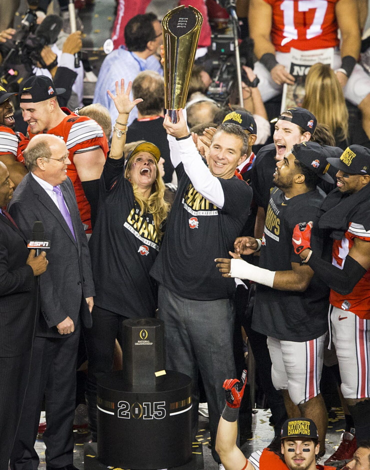 Ohio State Buckeyes head coach Urban Meyer hoists the trophy after a victory over the Oregon...