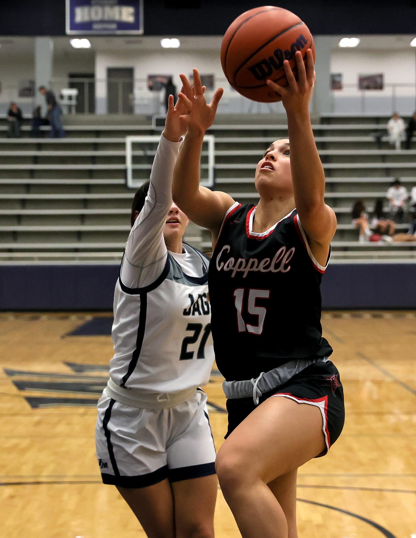 Coppell guard Atia Medenica (15) goes strong to the basket against Flower Mound guard...