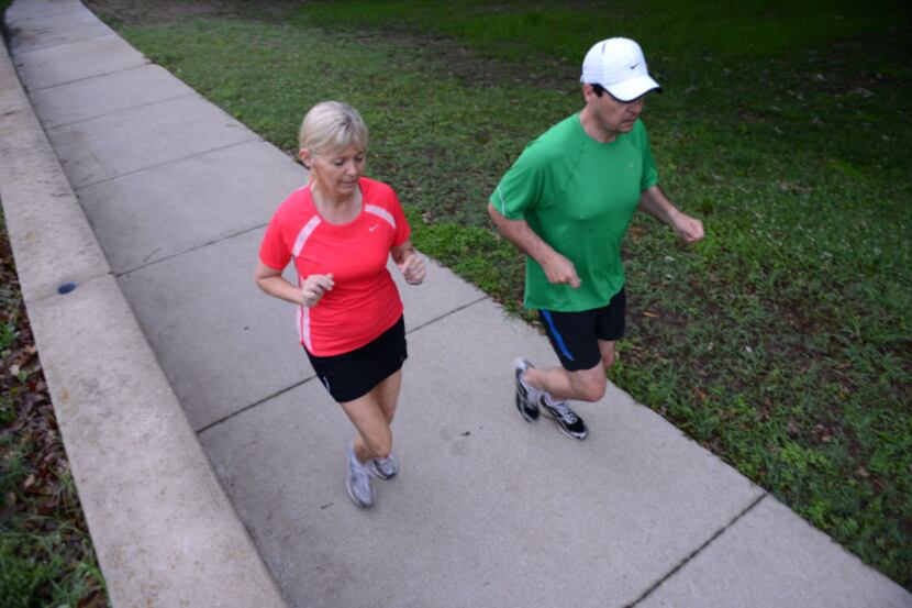 Gavin and Cindy Goodrich go for an early morning run in Foxboro Park, near their Fairways of...