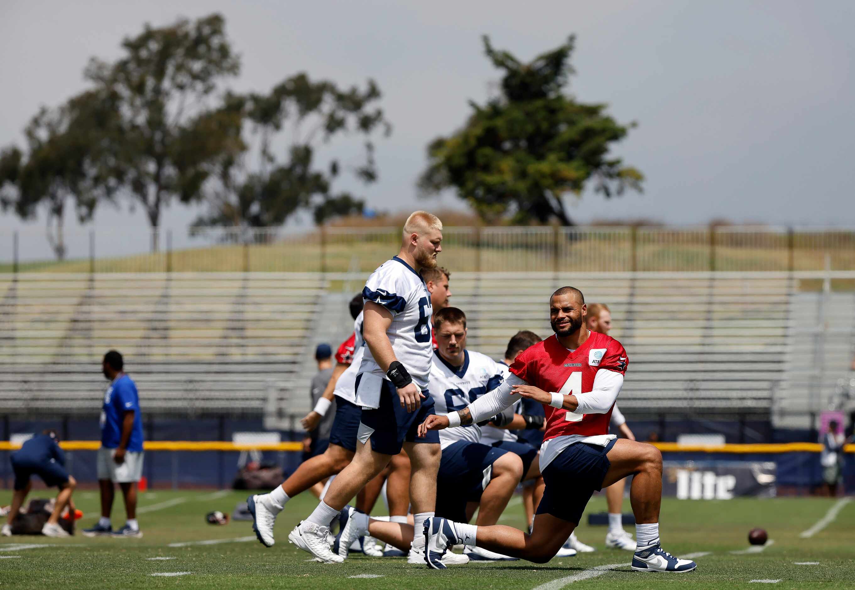 Dallas Cowboys quarterback Dak Prescott (4) and his lineman stretch before the first 2022...