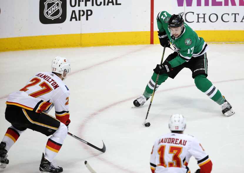 Dallas Stars center Devin Shore (17) moves the puck against Calgary Flames defenseman Dougie...