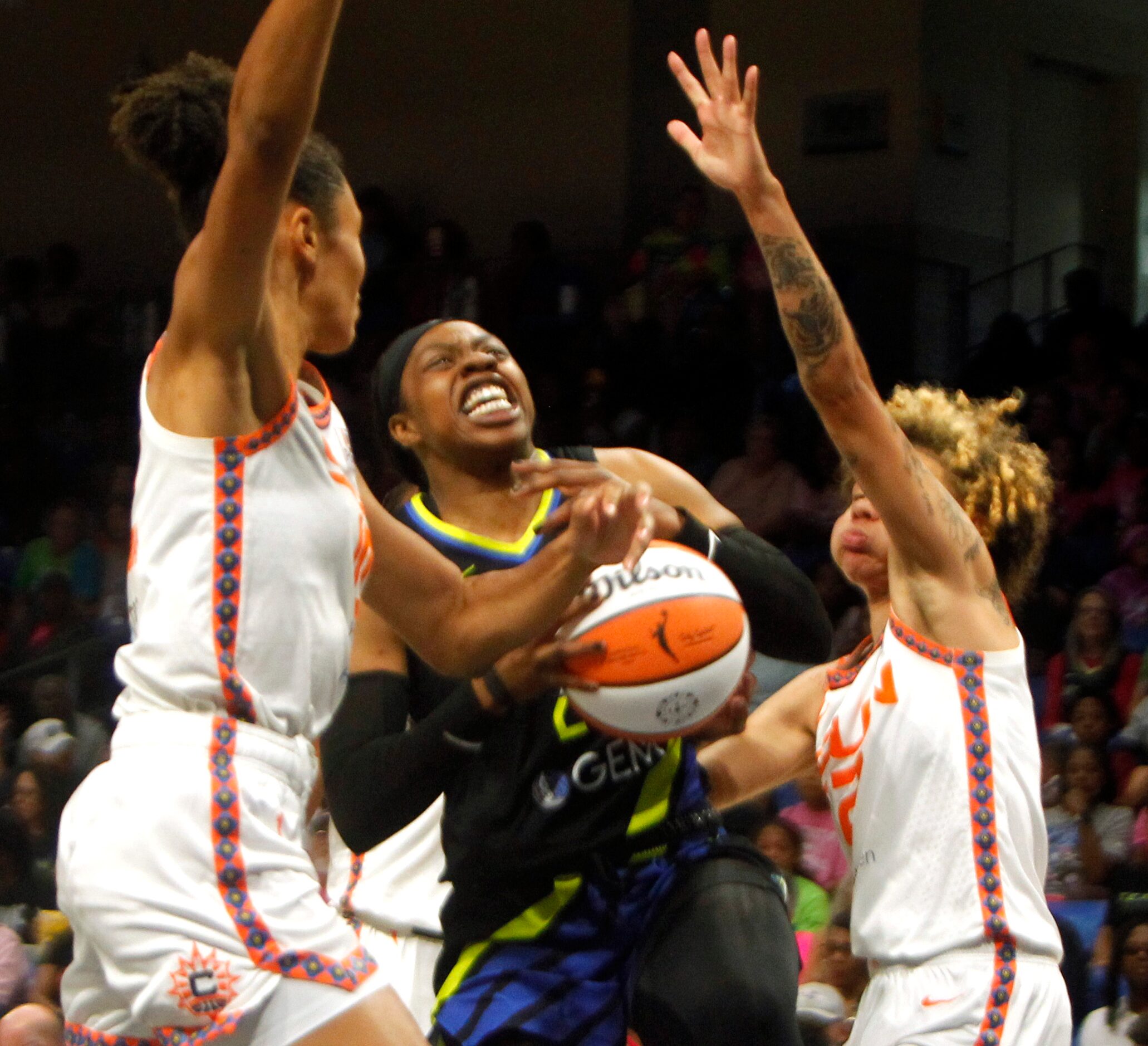 Dallas Wings guard Arike Ogunbowale (24) is fouled by Connecticut Sun guard Natisha Hiedeman...