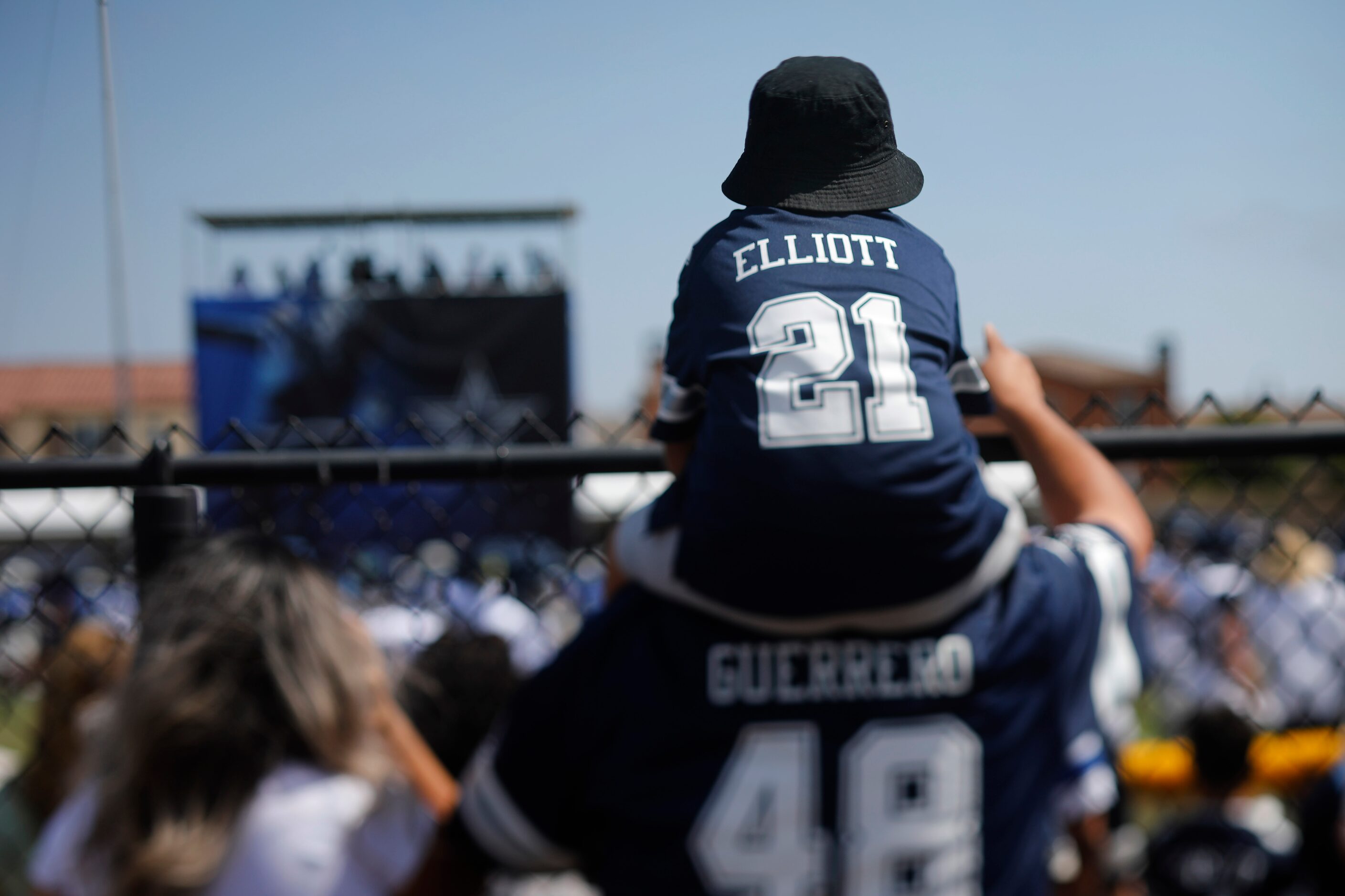 A young Dallas Cowboys fan gets a higher vantage point to watch a scrimmage against the Los...