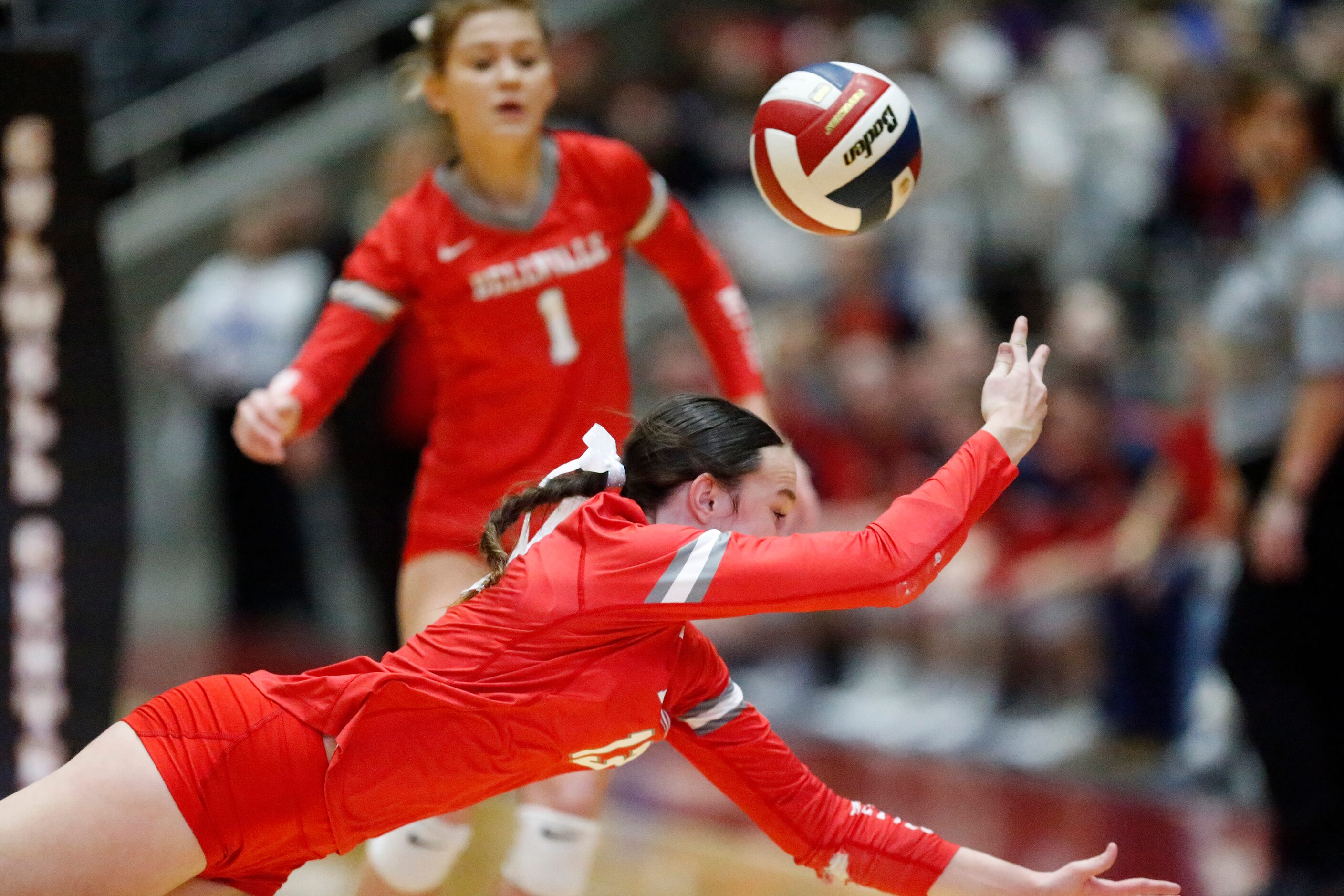 Bellville High School's Sydney McKay (13) makes a diving attempt to keep the ball in play...