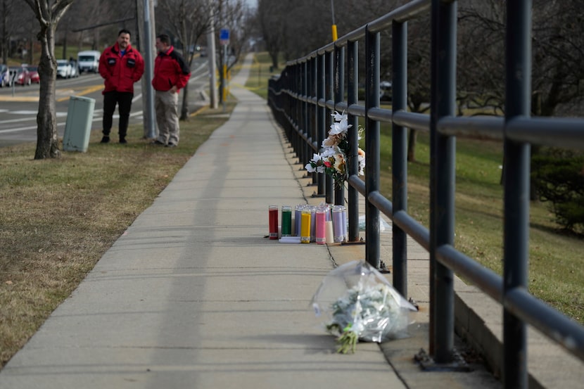 Flowers and candles are placed outside the Abundant Life Christian School Tuesday, Dec. 17,...