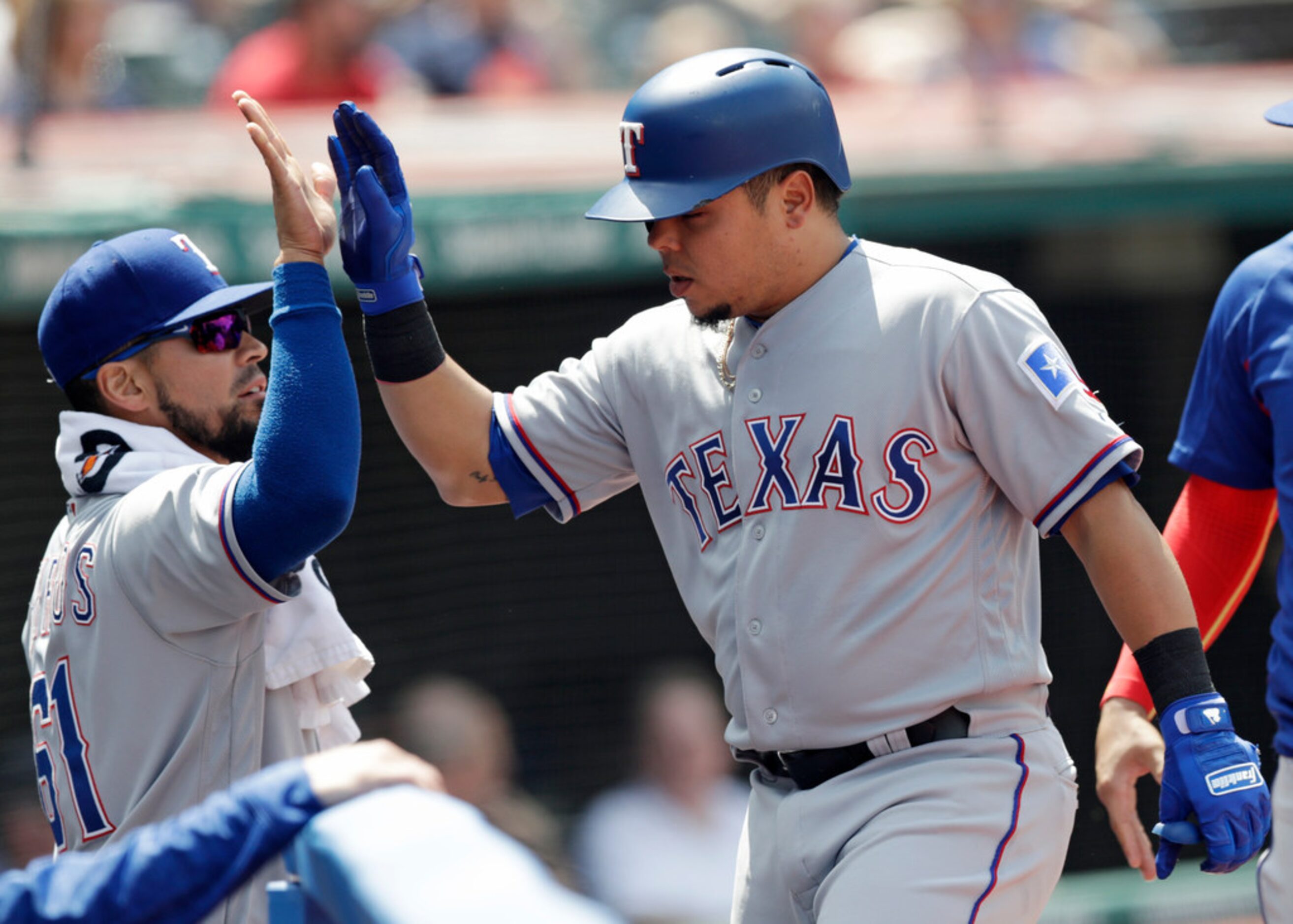 Texas Rangers' Juan Centeno, right, is congratulated by Robinson Chirinos after Centeno hit...