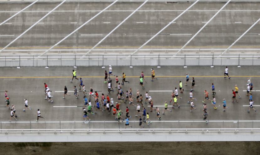 Runners make their across the Margaret Hunt Hill Bridge during the MetroPCS Dallas Marathon...