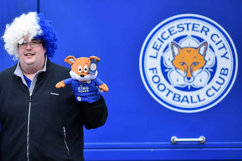 (FILES) This file photo taken on April 24, 2016 shows a Leicester City fan posing for a...