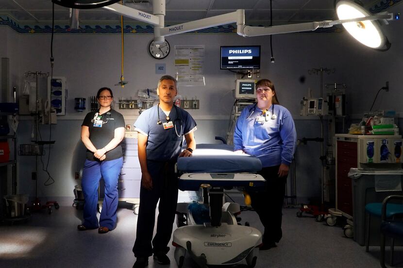 Dr. Daniel Guzman (center) and registered nurses Deborah Freeman (left) and Celeste Calhoun...