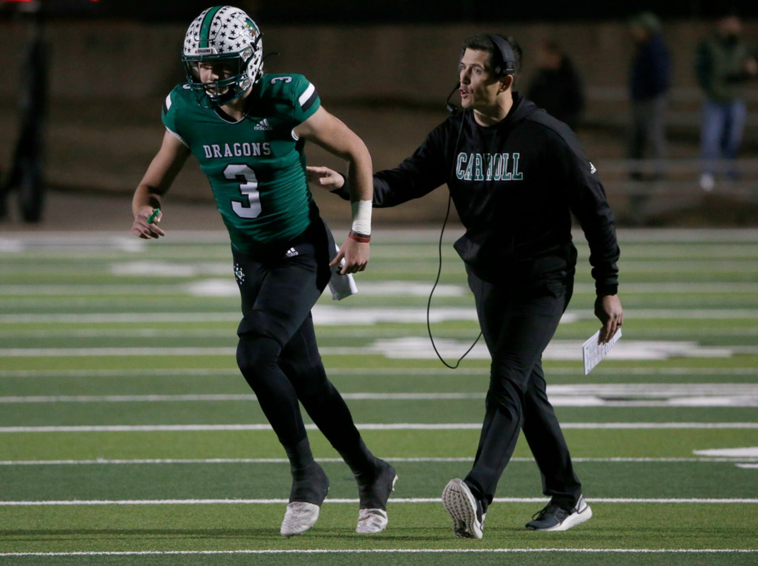Southlake quarterback Quinn Ewers (3) gets directions from head coach Riley Dodge as they...