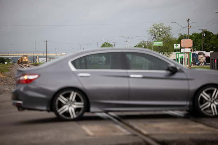 A driver goes through the railroad intersection at Jefferson St. and Center St. in Grand...