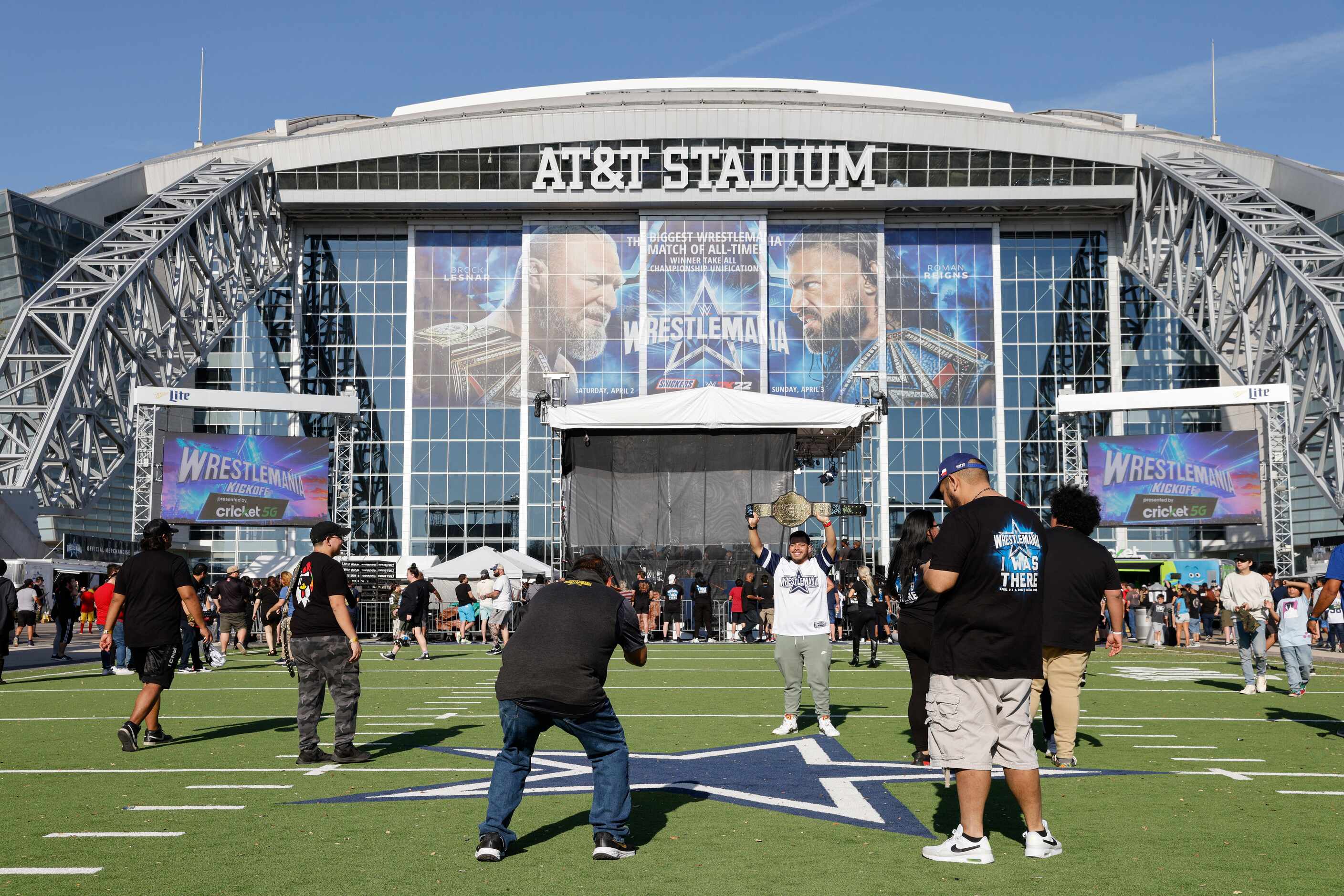 Fans pose for pictures before WrestleMania Sunday at AT&T Stadium in Arlington, Texas,...
