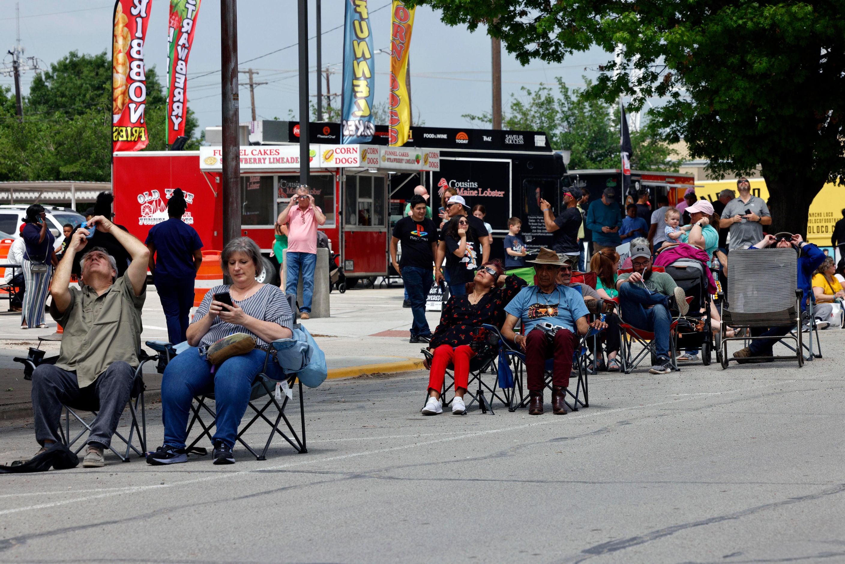 People view a partial solar eclipse in the town square, Monday, April 8, 2024, in Hillsboro,...