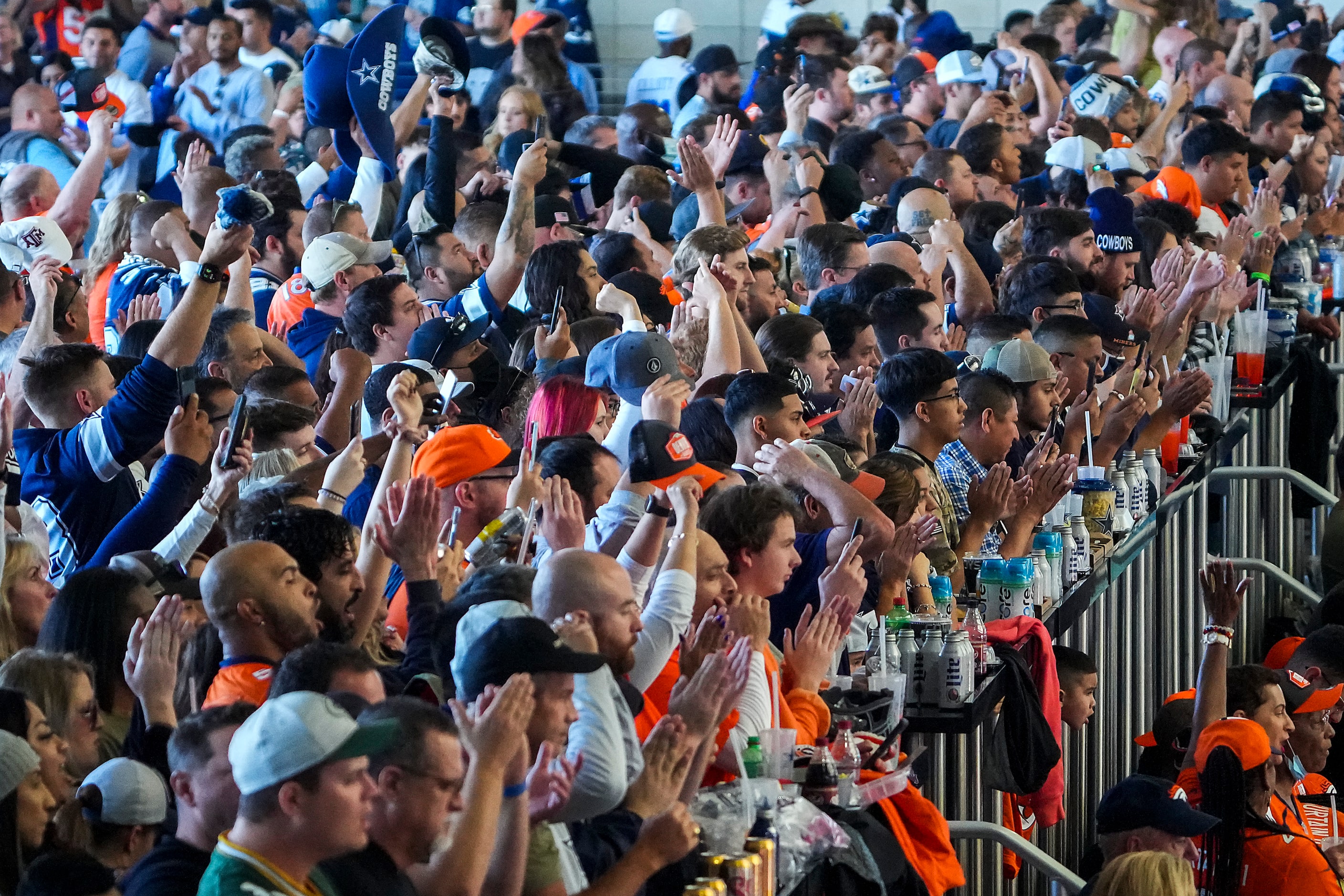 Fans jam the standing room only section of the upper concourse before an NFL football game...