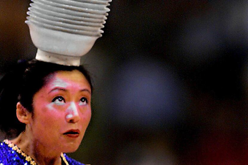  April 24, 2002--Krystal Magic catches 15 bowls on her head that she has flipped up from her...
