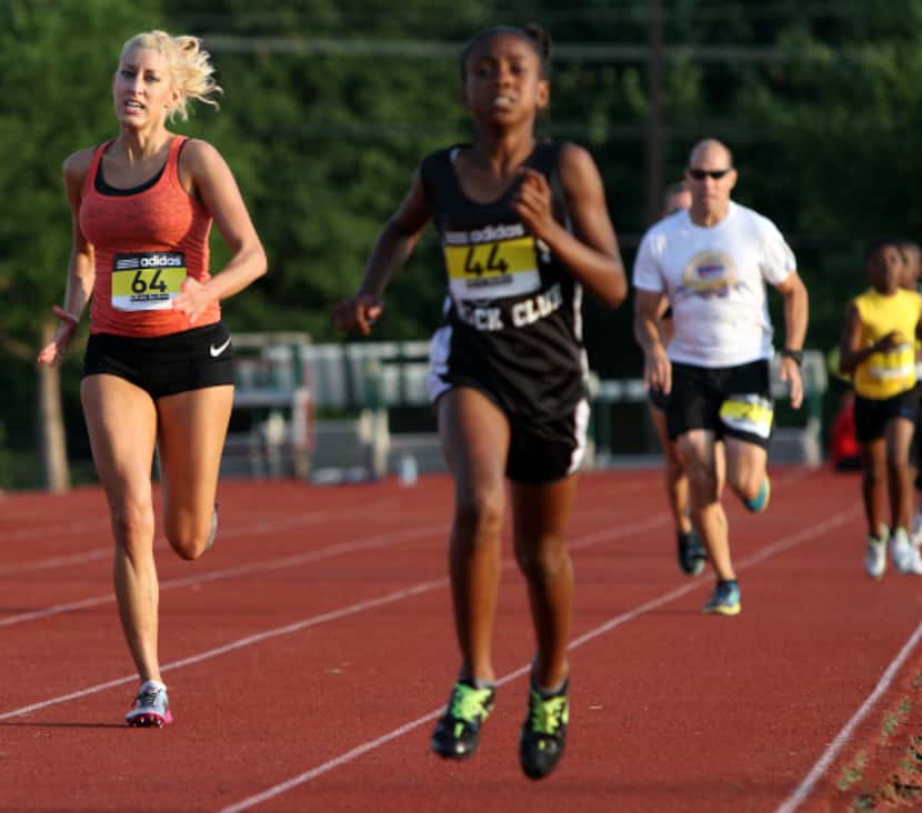 Robin Blair, 31, left, and Sierra Beal, 10, compete during the 400 meter race at the 29th...