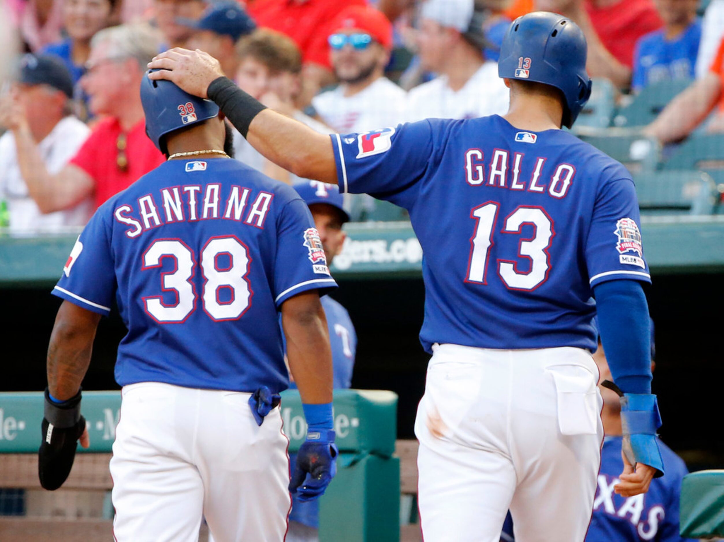 Texas Rangers Joey Gallo (13) taps Danny Santana (38) on the helmet after they both scored ...