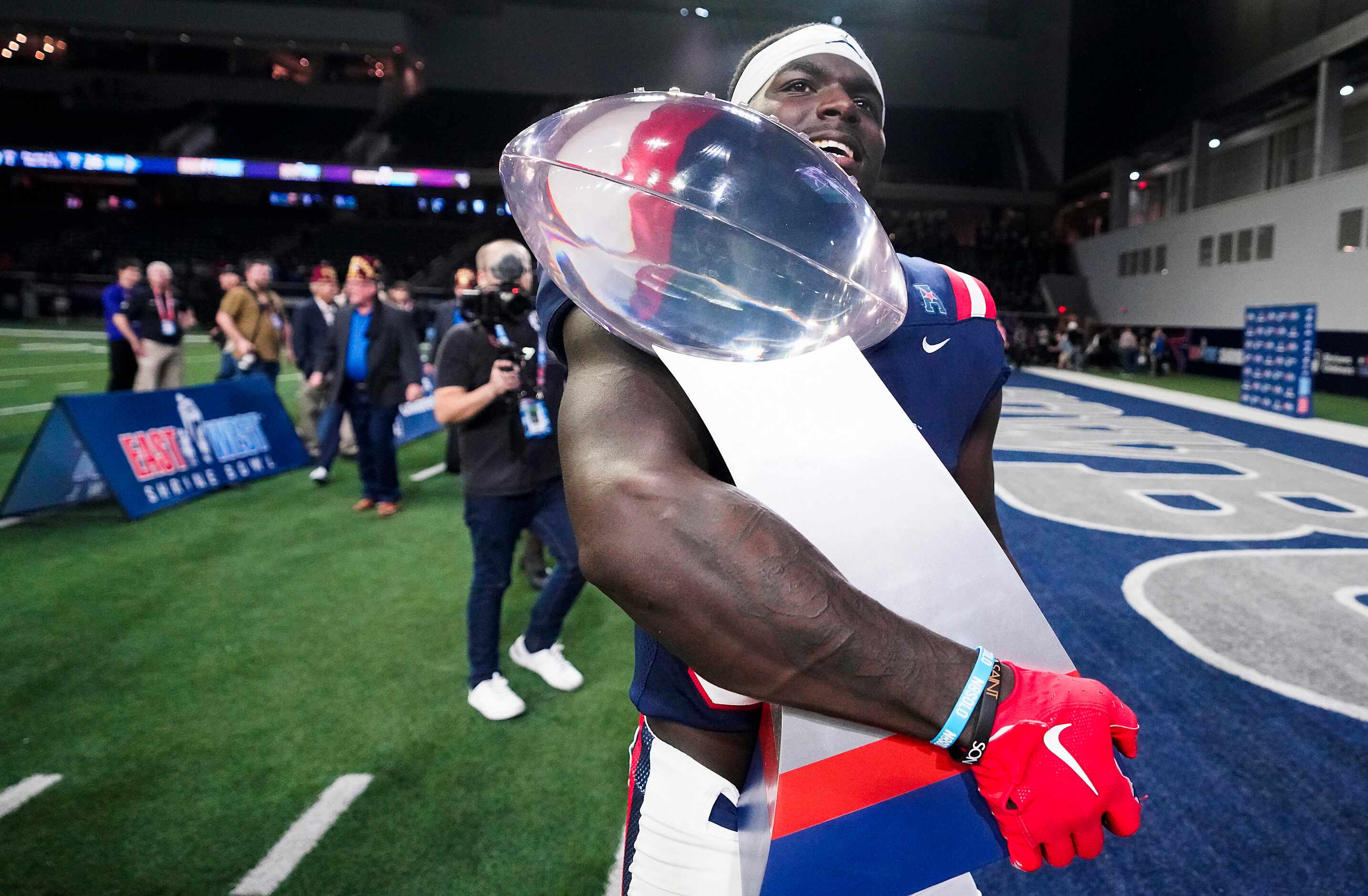 West defensive back Jarius Monroe of Tulane  (32) carries the game trophy from the field...