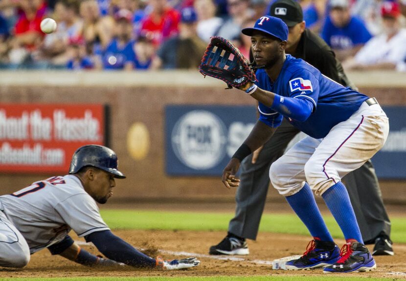 Houston Astros center fielder Carlos Gomez (30) makes it back to first base before Texas...