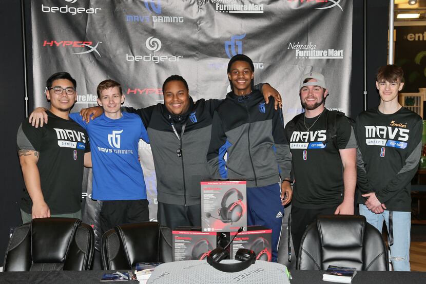 The Mavs Gaming squad poses for a photo at a local fan event before a meet and greet and an...