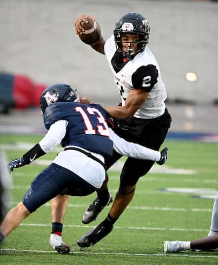 Euless Trinity's Ollie Gordon (2) runs past a tackle attempt by Allen’s Caden Dunlap (13) in...