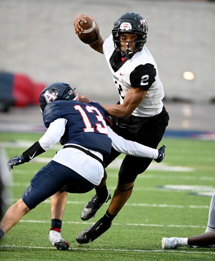 Euless Trinity's Ollie Gordon (2) runs past a tackle attempt by Allen’s Caden Dunlap (13) in...